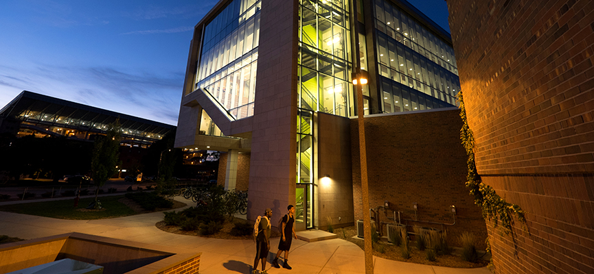 Photo of the eluminated B-Wing of Wells Hall at night.