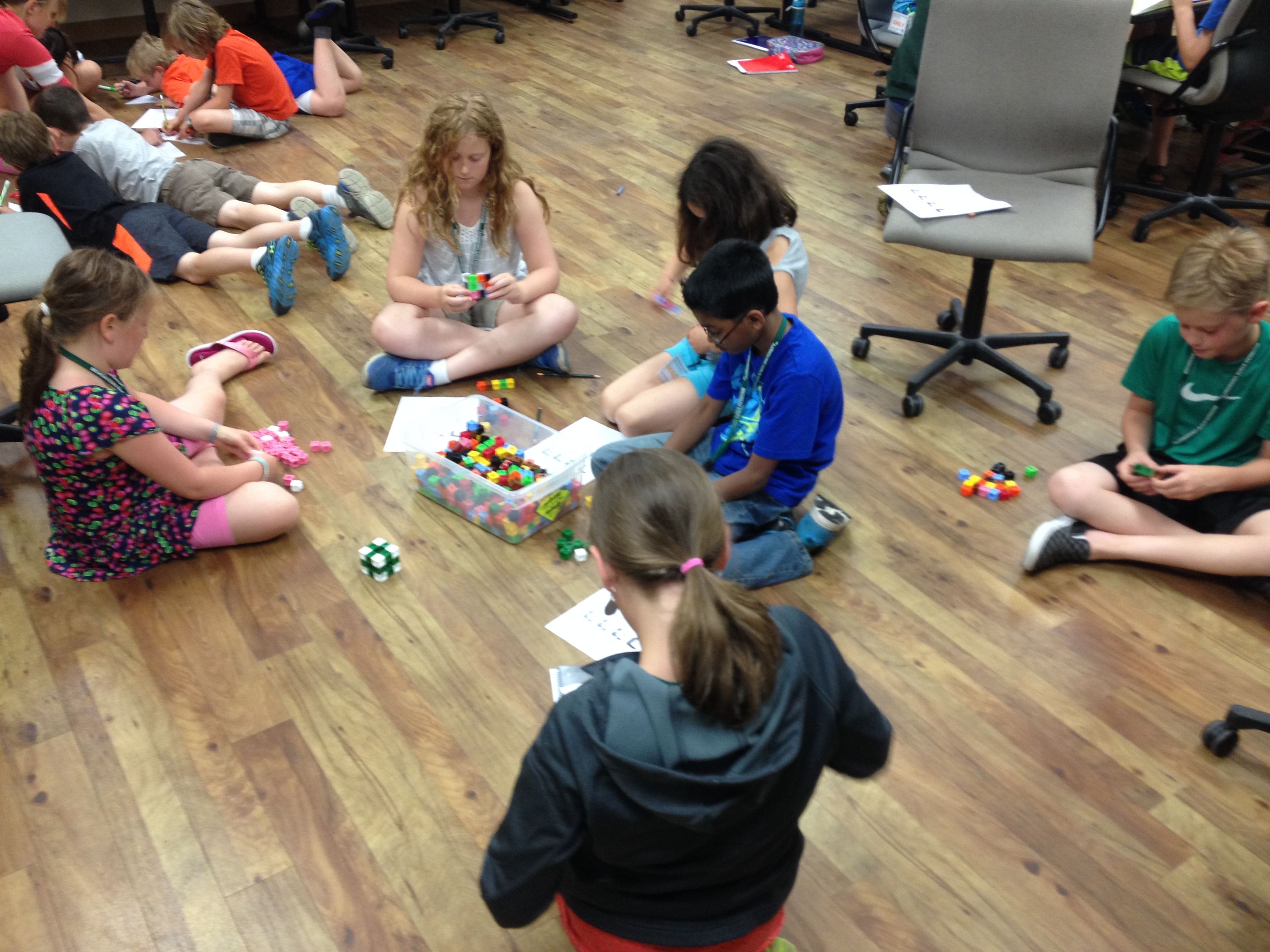 students sitting on the floor putting block pieces together